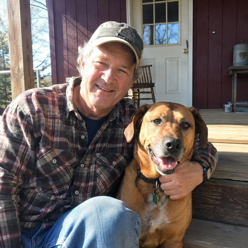 James on his porch with his dog